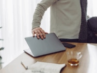 An employee shutting their laptop down as they prepare to go on Gardening Leave