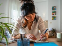 Young Asian Girl Entrepreneur Creative Freelance Working From Home Sitting And Drawing On A Notebook On The Table A Creative Design.