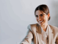 A woman shaking hands following successful salary negotiations