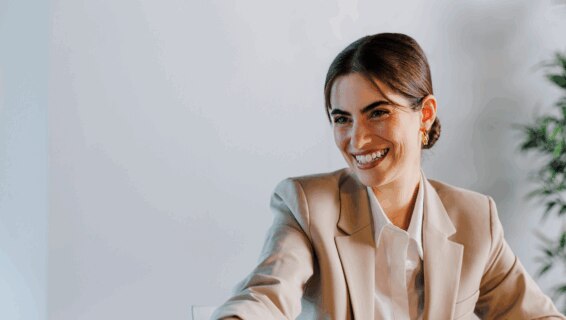 A woman shaking hands following successful salary negotiations