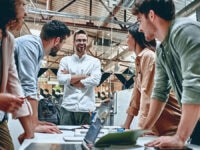 A group of work colleagues in a meeting with a senior manager