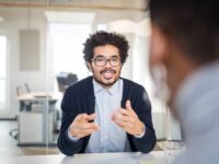 A manager conducting an exit interview with a departing employee in the office