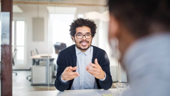 A manager conducting an exit interview with a departing employee in the office