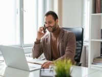 A recruiter on the phone to a candidate, demonstrating the value of candidate communication