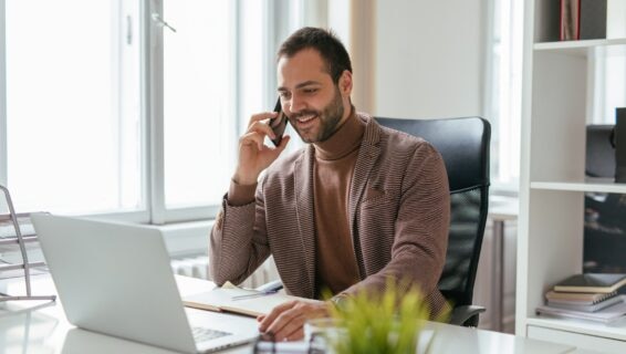 A recruiter on the phone to a candidate, demonstrating the value of candidate communication