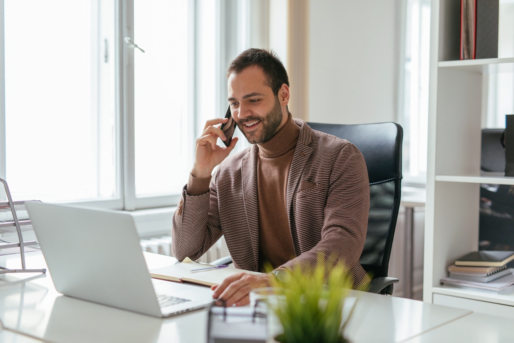 A recruiter on the phone to a candidate, demonstrating the value of candidate communication