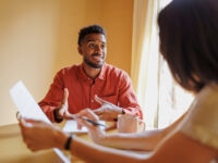 A job candidate and an interviewer having a productive conversation in an office environment