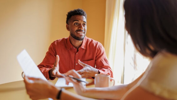 A job candidate and an interviewer having a productive conversation in an office environment