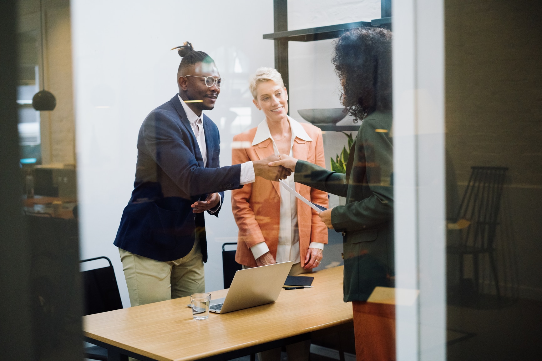 Colleagues shaking hands with an interview candidate