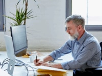 A business leader working in the office to calculate employee retention rate