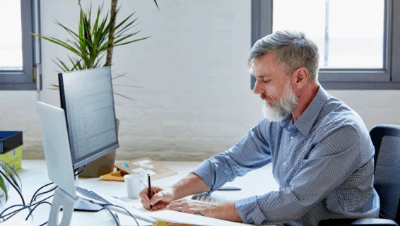 A business leader working in the office to calculate employee retention rate
