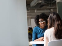 An image of a recruiter giving feedback to an interview candidate.