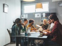 A small business team in a meeting room discussing recruitment strategies, highlighting hiring challenges small business leaders face such as skills gaps, limited resources and collaborative decision-making.
