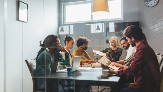 A small business team in a meeting room discussing recruitment strategies, highlighting hiring challenges small business leaders face such as skills gaps, limited resources and collaborative decision-making.