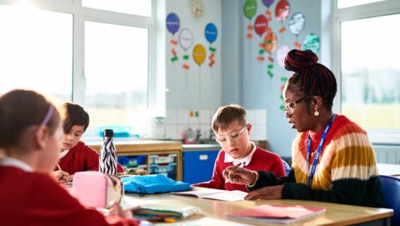 Teacher in class room with young students
