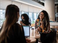 Two female colleagues sat opposite each other