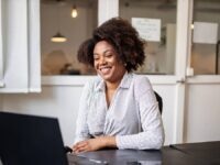A happy and engaged employee working at their desk