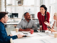 Business meeting where happy employees are discussing their growth strategy