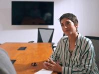 A woman sitting in an interview, highlighting how interviews are essential to speeding up the hiring process
