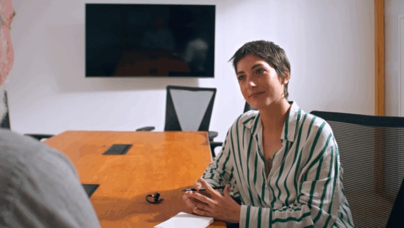 A woman sitting in an interview, highlighting how interviews are essential to speeding up the hiring process