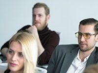 A group of employees attending a workplace training session, illustrating how to upskill your workforce through professional development and learning programmes.