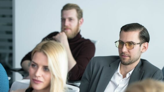 A group of employees attending a workplace training session, illustrating how to upskill your workforce through professional development and learning programmes.