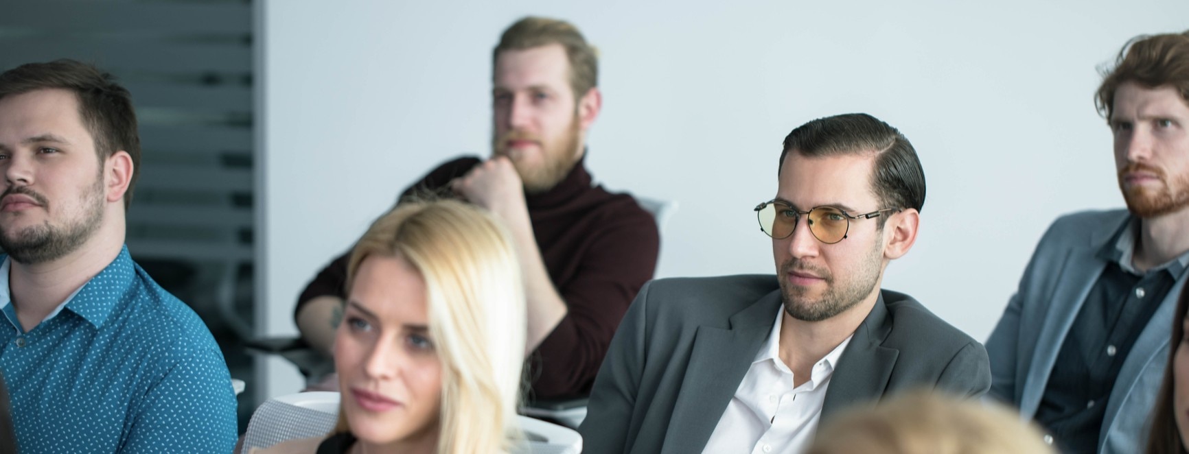 A group of employees attending a workplace training session, illustrating how to upskill your workforce through professional development and learning programmes.