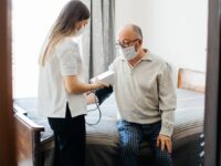 A care assistant taking care of a patient in a care home environment