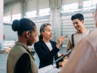 An age diverse group of employees discussing plans