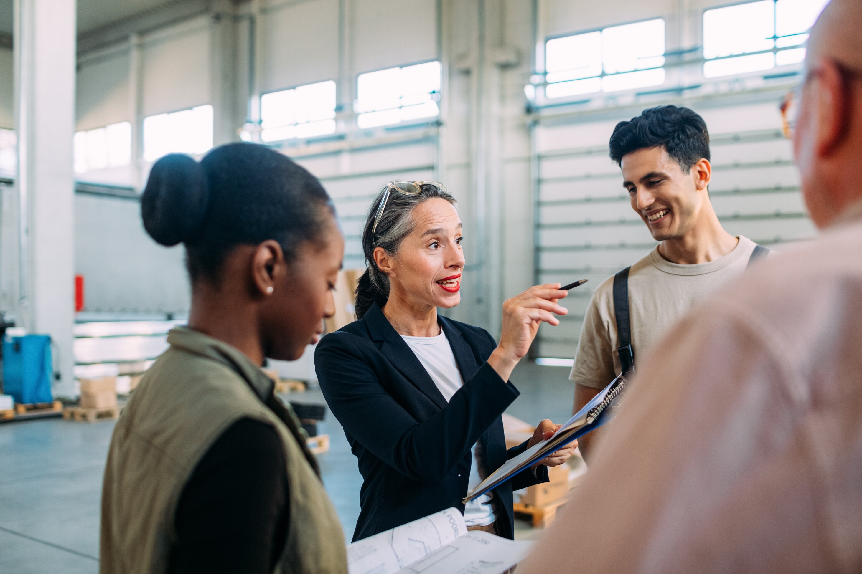 An age diverse group of employees discussing plans