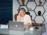 A senior manager struggling to deal with staff absences in a modern office space