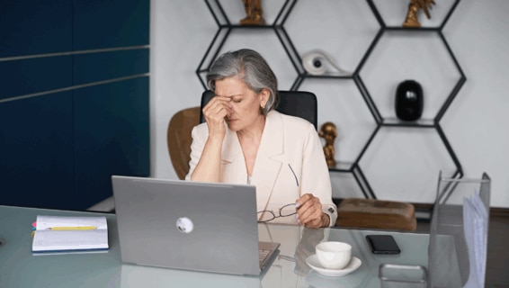 A senior manager struggling to deal with staff absences in a modern office space