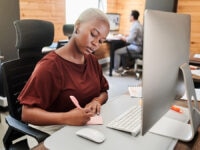 A hiring manager making notes before writing a job ad for a vacancy